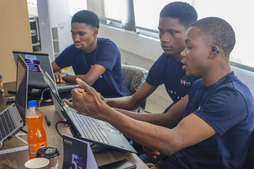 Some members of Team Epsilon building at the hackathon in November 2025.