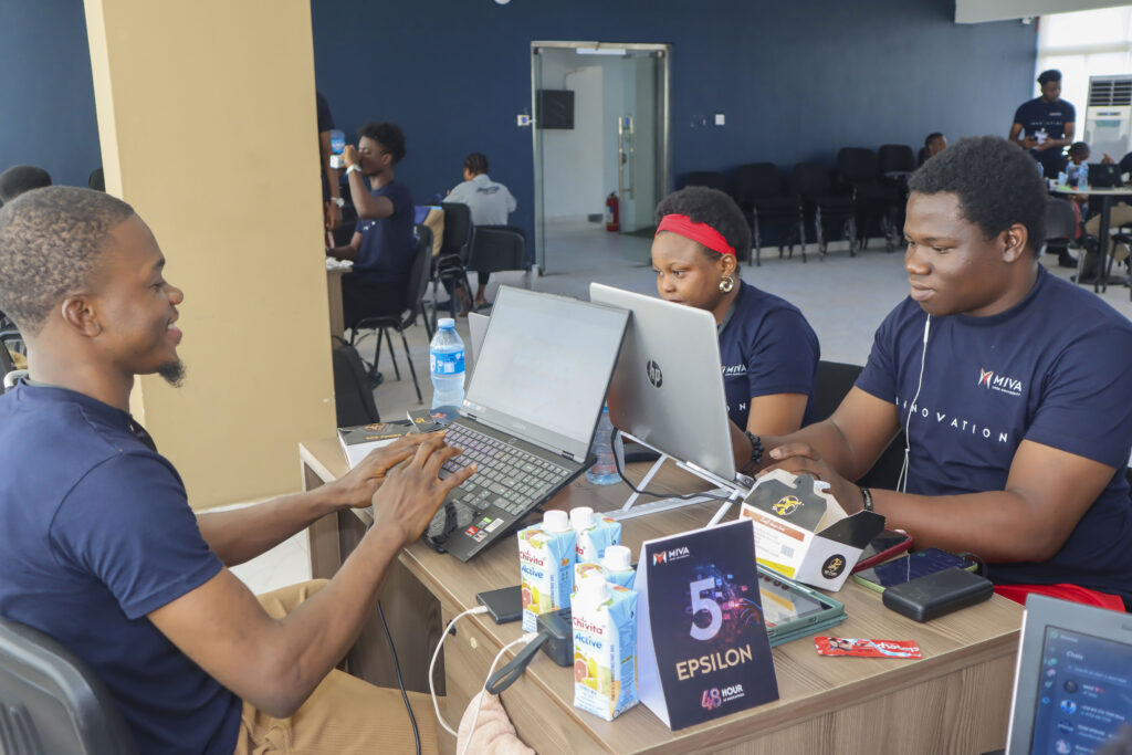 Some members of Team Epsilon building at the hackathon in November 2025.